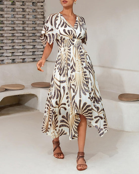 Elegancka sukienka o nieregularnym kroju z nadrukiem i dekoltem w kształcie litery V