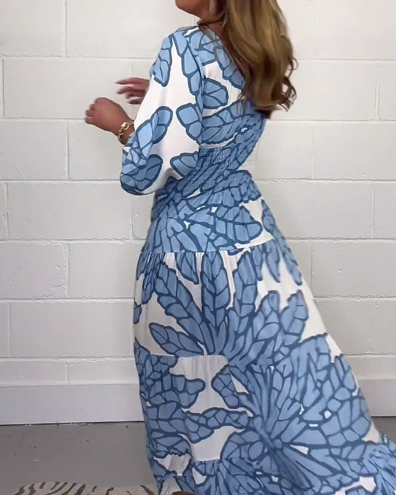 Długa damska sukienka z nadrukiem i dekoltem w kształcie litery V