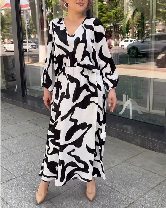 Elegancka sukienka z długimi rękawami w modny wzór