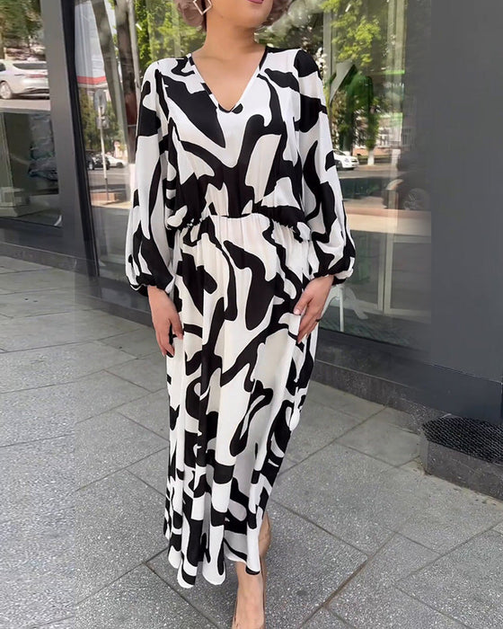 Elegancka sukienka z długimi rękawami w modny wzór