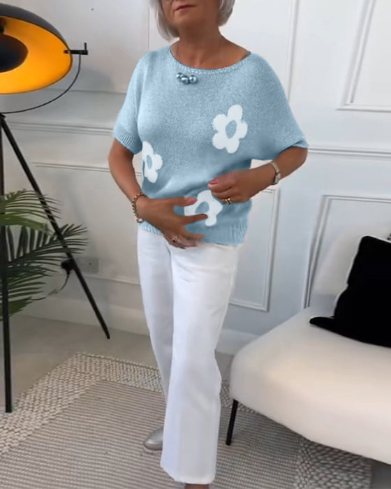 Wąski sweterek w kwiaty z okrągłym dekoltem