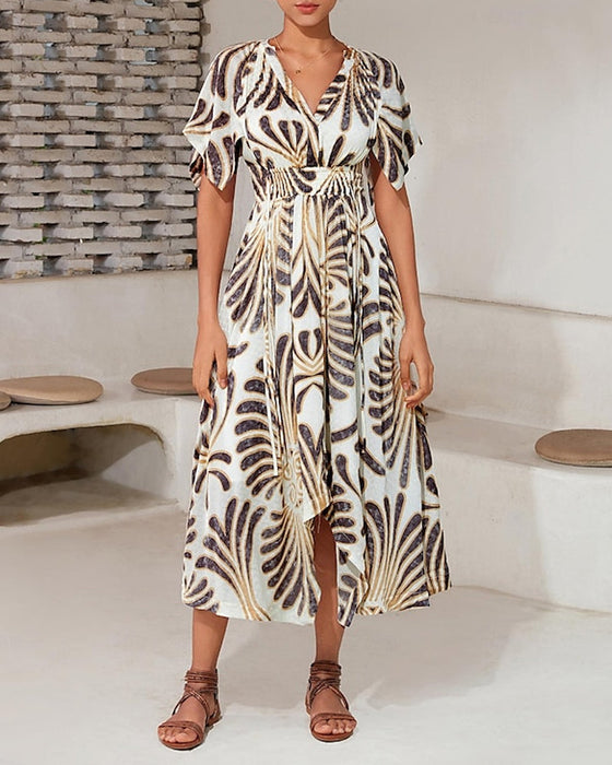 Elegancka sukienka o nieregularnym kroju z nadrukiem i dekoltem w kształcie litery V