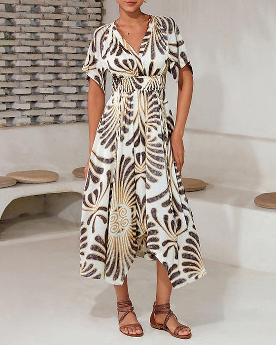Elegancka sukienka o nieregularnym kroju z nadrukiem i dekoltem w kształcie litery V