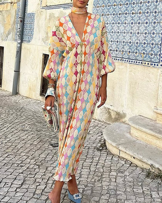 Elegancka sukienka z dekoltem w kształcie litery V rękawami typu lampion i geometrycznym nadrukiem