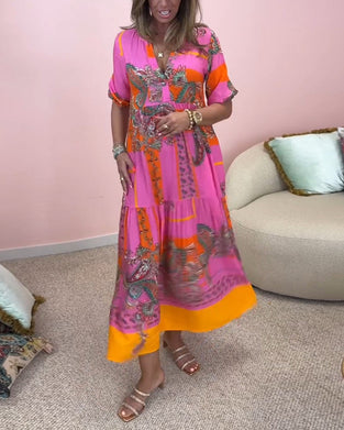 Elegancka, luźna, długa sukienka z głębokim dekoltem w kształcie litery V