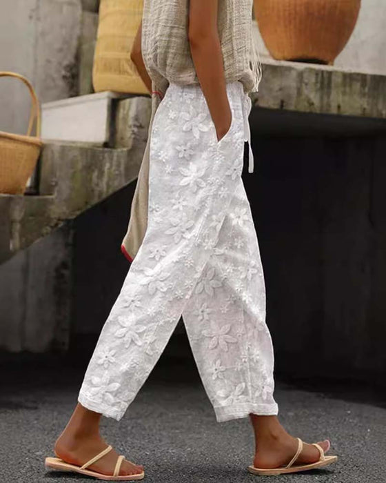 Sznurowane spodnie w jednolitym kolorze z kwiatowym haftem